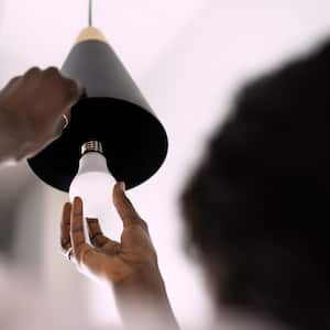 A woman adding new LED bulb