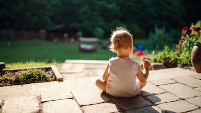 Child sitting in backyard