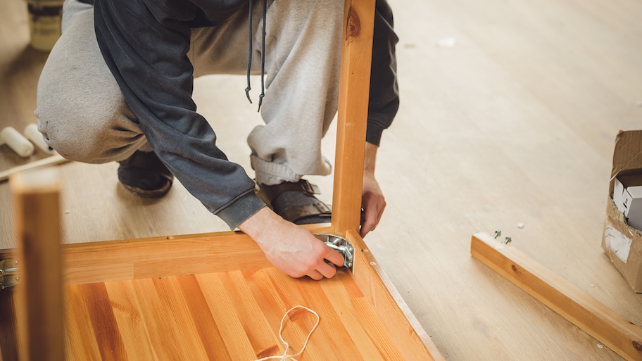 man assembling wood table 