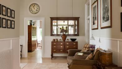 An antique wooden drawers and mirror in hallway