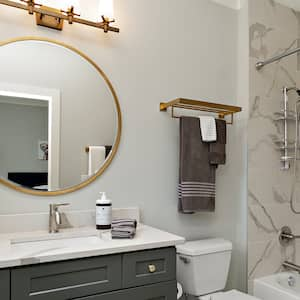 Gold round mirror in small bathroom