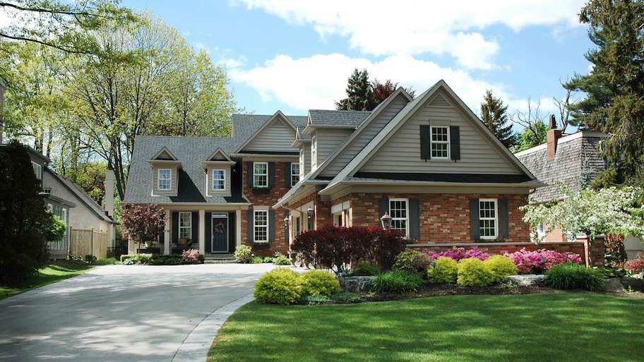 House with brick on lower and grey siding on upper