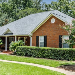 Front view of red brick house in the suburbs