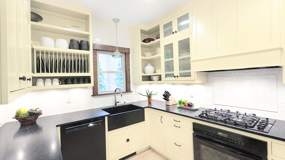 Cream cabinets with black countertops in kitchen