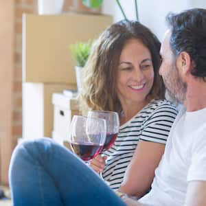 A couple drinking wine after moving in in their new house