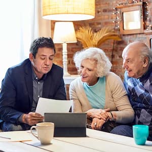 Senior couple meeting with financial advisor at home