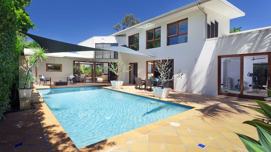 House with a backyard swimming pool and terracotta floor