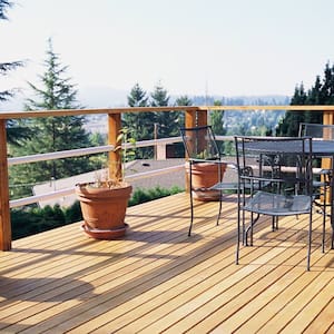 A metal table and chairs on a wooden deck
