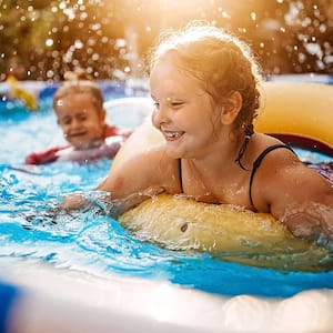 Children play in an above ground pool