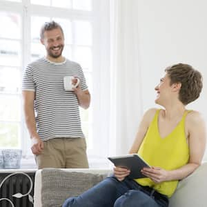 Happy young couple in living room at home