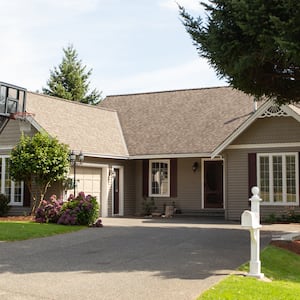 suburban house with basketball hoop in driveway