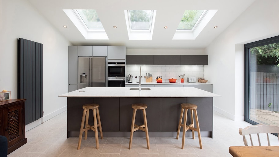 A modern kitchen with an island and a skylight