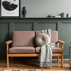 A stylish living room with panelling on the wall and decorative plants