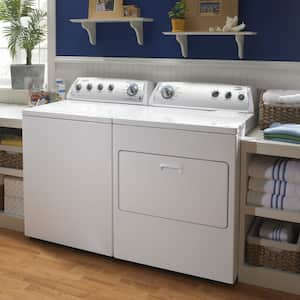 washer and dryer with shelves beside and above