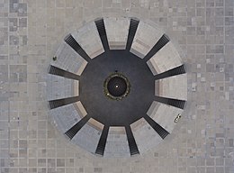 A girl putting flowers to Armenian Genocide memorial. View from top.jpg