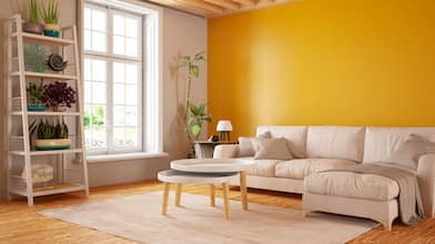 interior living room with glossy orange painted wall and tan furniture