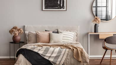 Neutral toned bedroom with bed and desk