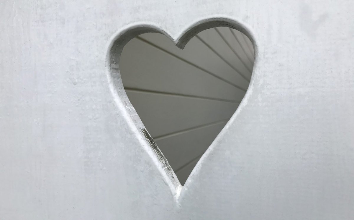 Heart cut out of wood painted white.
