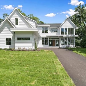 White siding on modern farmhouse in residential neighborhood