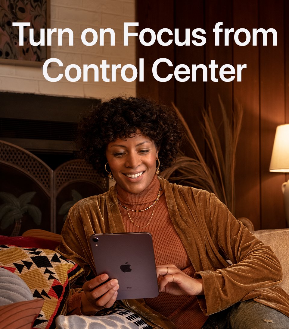 How to turn on Focus from Control Center. A person is relaxing on the couch with their iPad mini.
