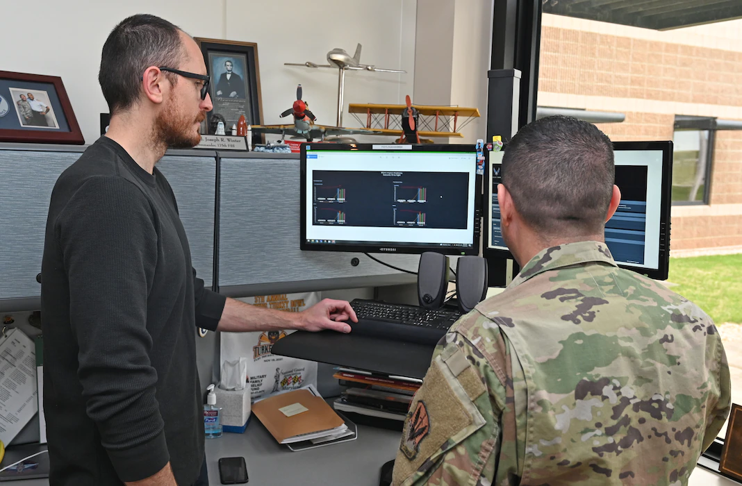 U.S. Air Force Lt. Col. Joseph Winter, 175th Force Support Squadron commander and field grade officer advisor, speaks with Joe Grigg, CyberWinter Studios founder, about the best practices for the CyberWinter Studios program the 175th Wing will be using in the future. The CyberWinter Studios is the first funded program from the 175th Spark Cell. (U.S. Air National Guard photo by Master Sgt. Chris Schepers)