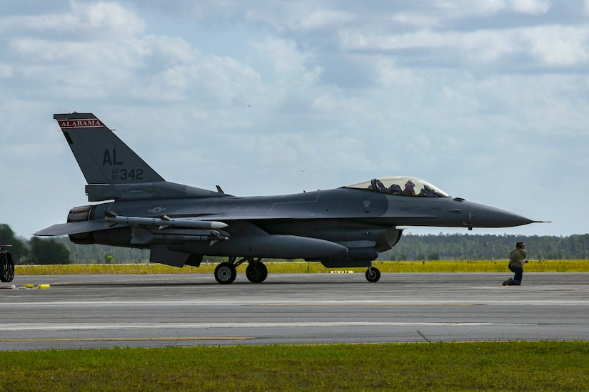 A fighter jet sits on a runway.