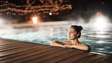 woman in a heated swimming pool at night