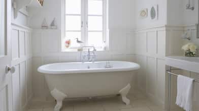 white freestanding bathtub in white bathroom