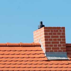 A roof with red tiles and chimney