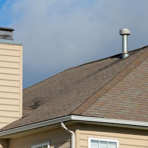 A galvanised metal chimney with a rain cap