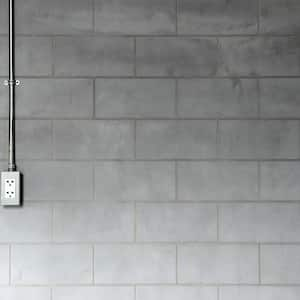 Steel pipe electric outlet on cement wall 