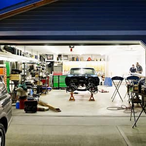 Home garage with door open at night