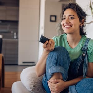 woman watching tv on the sofa