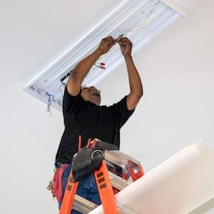 An electrician installing new lights