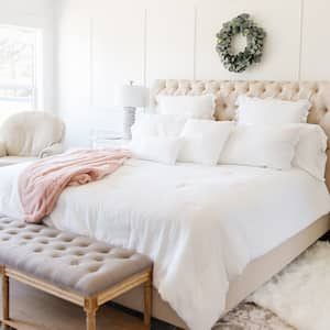 White bedroom with upholstered headboard