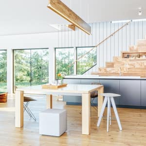 An open-plan kitchen and living room with large windows