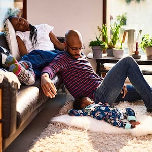 Parents and baby resting in the living room