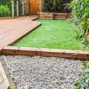 Yard with wooden decking and artificial grass