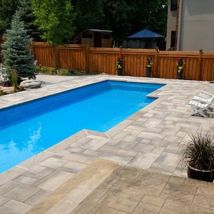 A house’s backyard with a fiberglass swimming pool