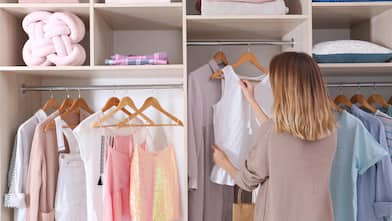 A woman browsing her closet for an outfit 