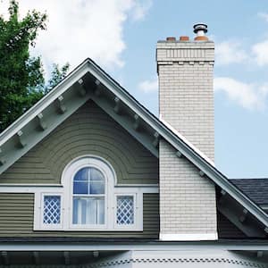 Exterior detail of a victorian house roof with chimney