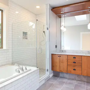 Modern bathroom with white subway tile and wood cabinets