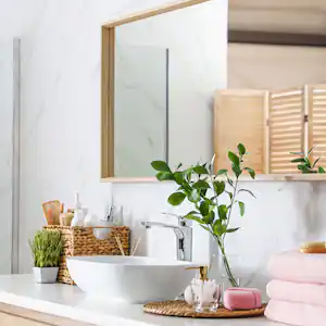 A large mirror over the sink in a modern bathroom
