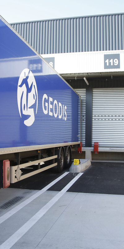 Truck in front of the entrance of a warehouse