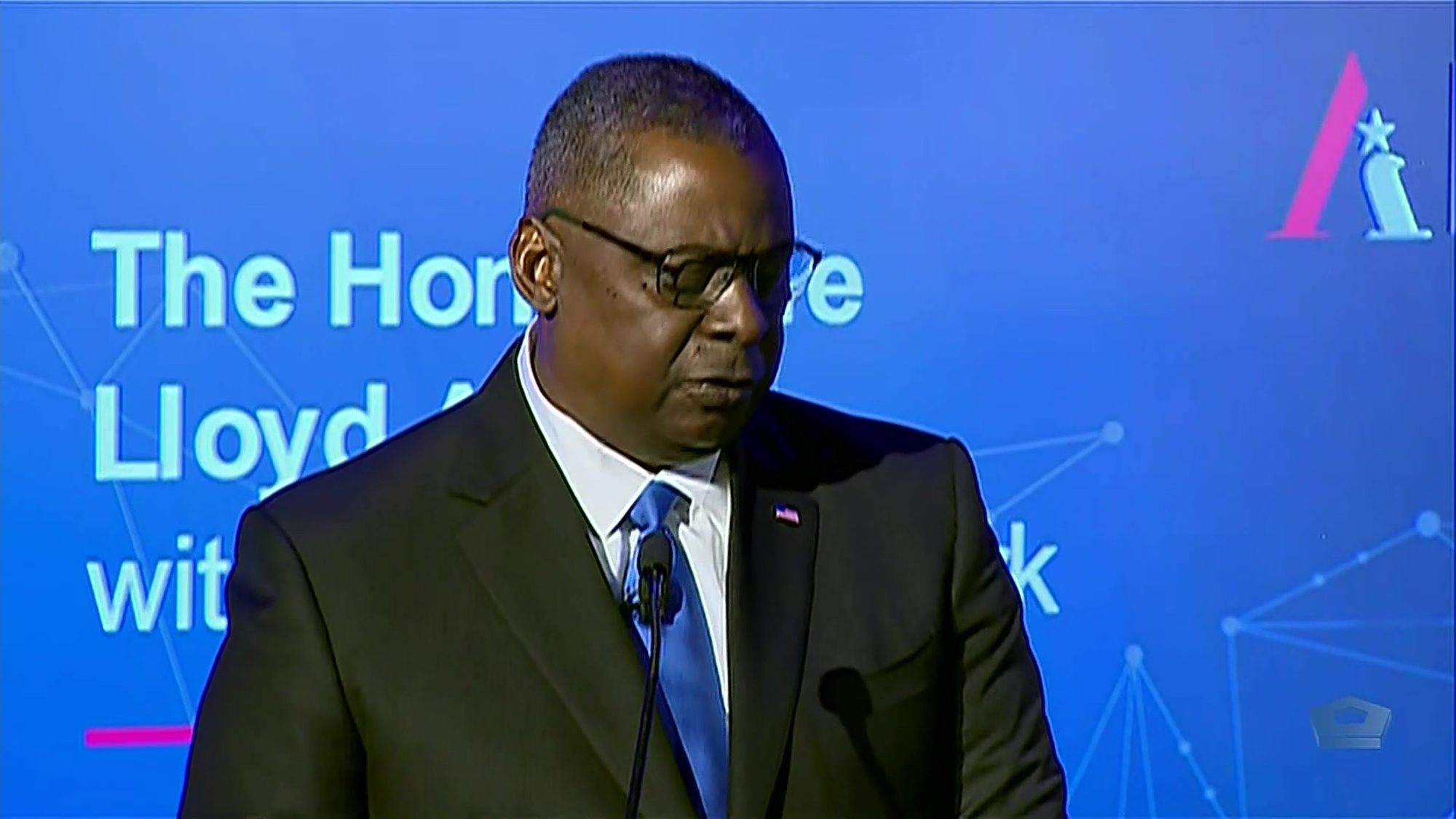 Secretary of Defense Lloyd J. Austin III speaks into microphone. 