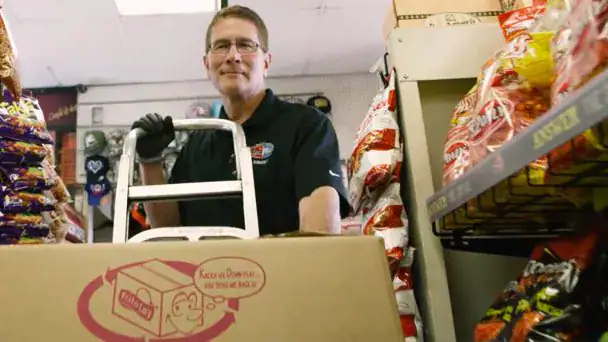 Worker delivers snacks to retail store