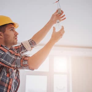 Electrician fixing a light bulb