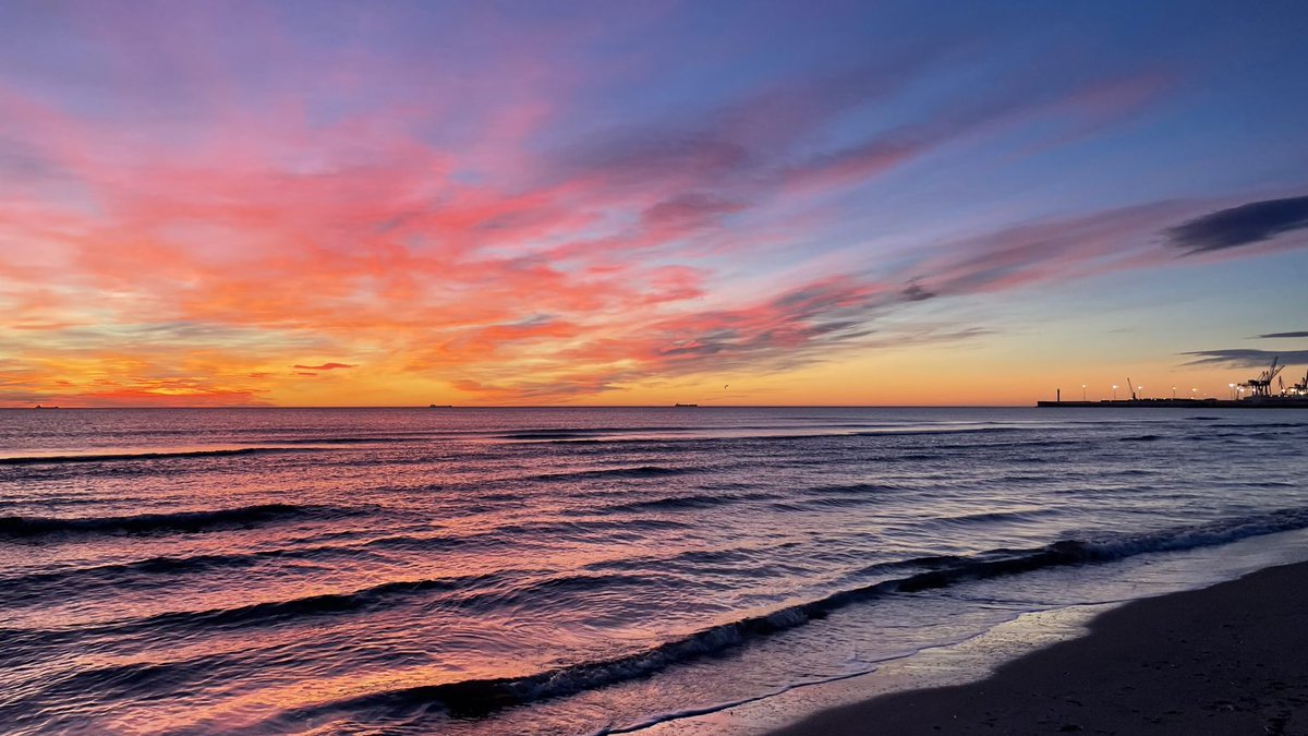Colorful sunset beach with yellow, purple and orange color tone.
