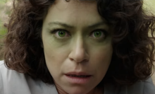 Tatiana Maslany as She-Hulk during a moment of transformation, with her face turning green.