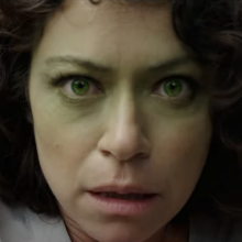 Tatiana Maslany as She-Hulk during a moment of transformation, with her face turning green.